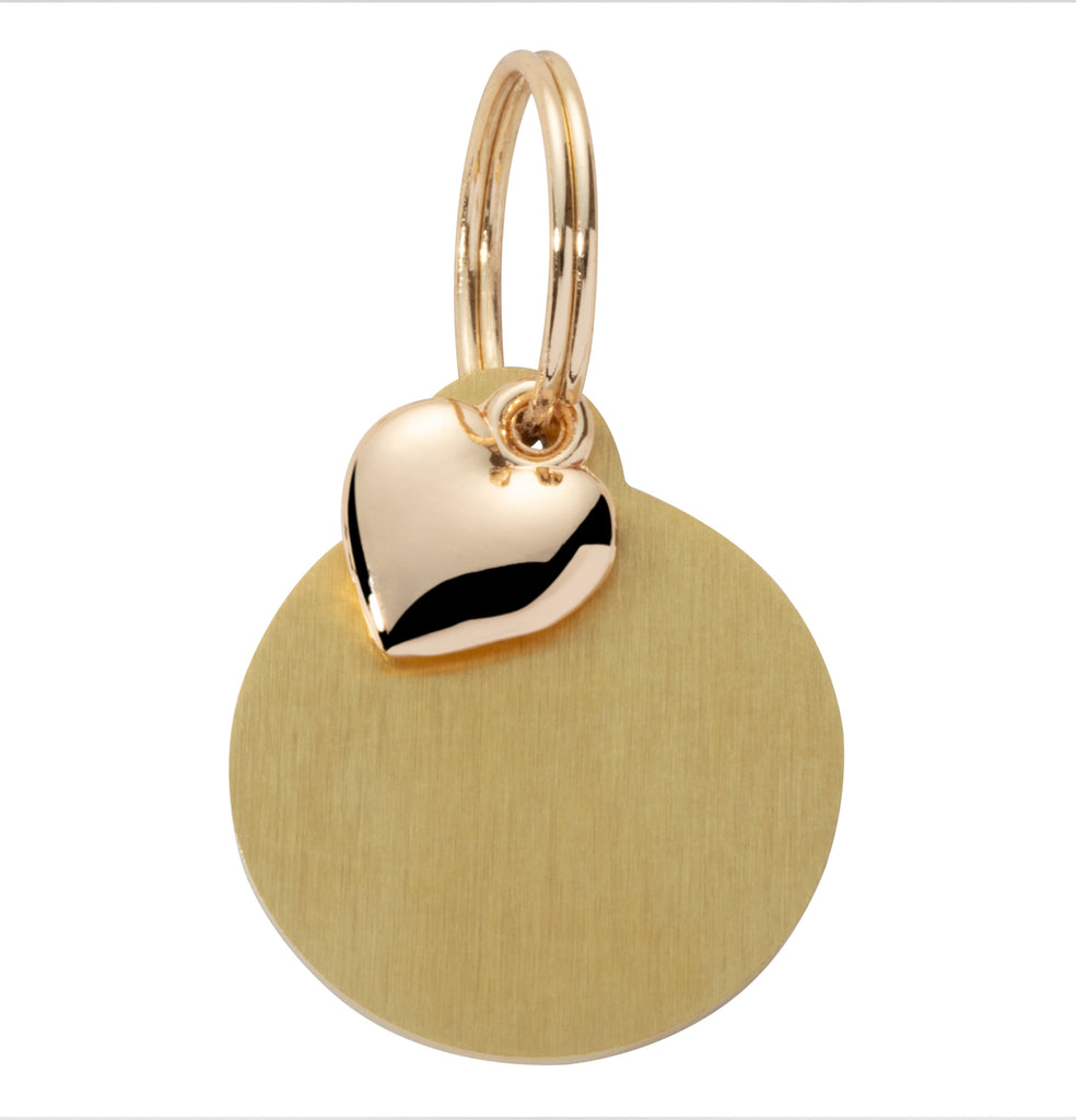 Gold pendant with heart-shaped tag on a white background
