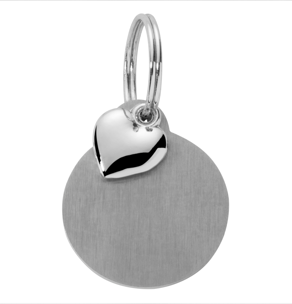 Silver heart-shaped pendant on a round tag against a white background